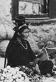 a woman sits near vegetables