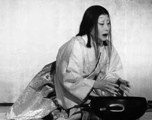 photo of a person in a noh mask