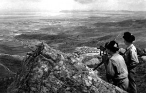 people taking photos of a distant valley