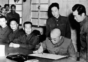 men in military uniforms and signing documents