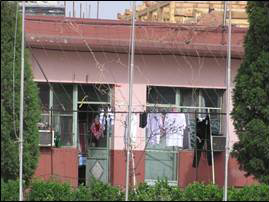 view of residence lodging with laundry hanging out to dry outside