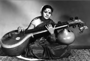 photo of a woman in a sari playing a vina