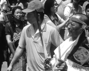 Sword-wielding Daoist shaman emerging from the Mazu Temple in Lugang.