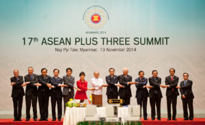 ASEAN members stand and cross hands at the 17th ASEAN Plus Three Summit in 2014. 