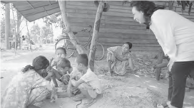 Image shows a man watching happy children at play