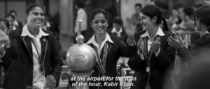 photo of three young women smiling and holding a trophy