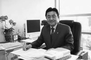 photo of a man in a suit at a desk