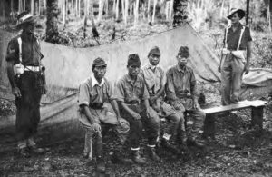 Two Australian military policemen guard Japanese prisoners