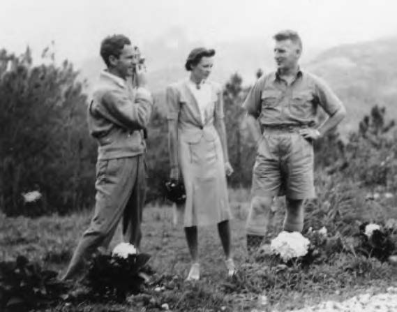 photo of two men and woman speaking together