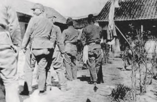 Japanese soldiers waiting in line at a comfort station. 