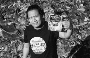 Global Anti Incineration Alliance Philippines Executive Director Froilan Grate shows a discarded pack of a Nestle product as he stands on a trash-filled shoreline along Manila Bay in Navotas City, Philippines. 