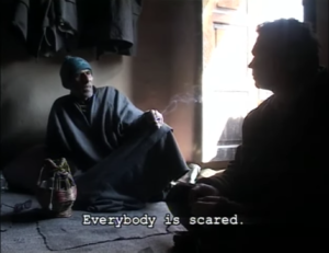 Ajay Raina speaks with a man from the village where his father lived in Kashmir.