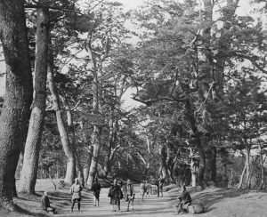 photograph of the Tokaido road, with several people walking both directions of the road.