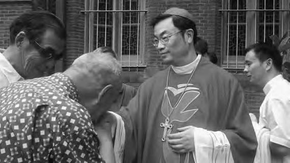 a photo of a man in priest robes blessing another man