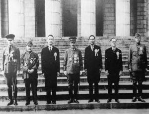 seven men in uniform stand next to each other.