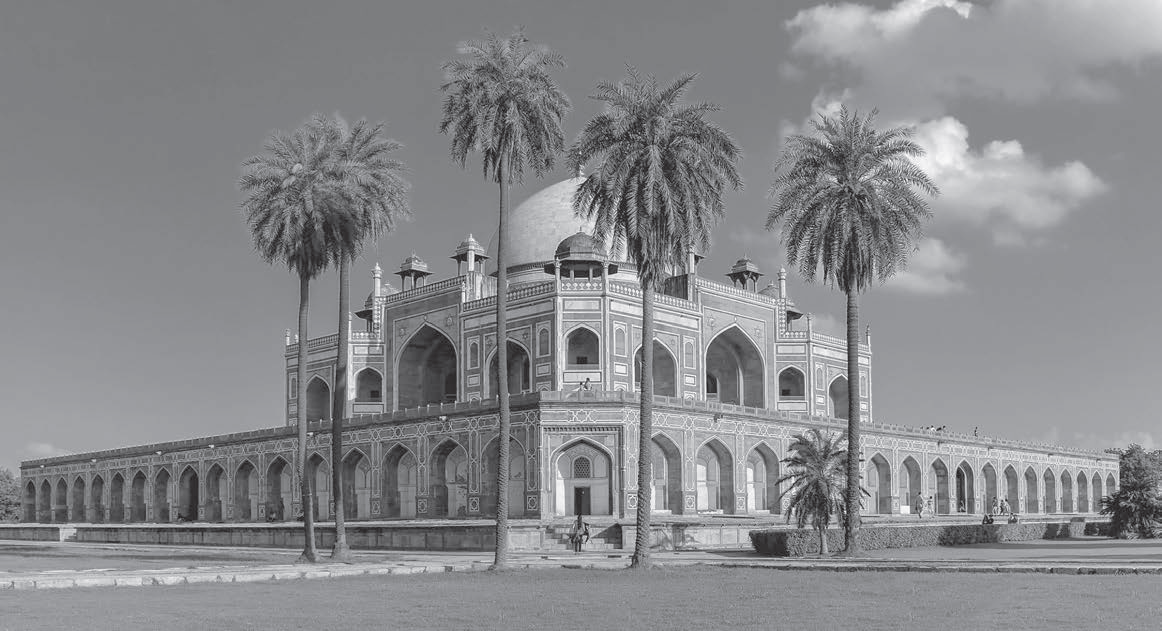 photo of a large palace with rounded ceilings, with palm trees in front of the palace