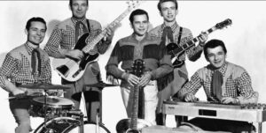 black and white photo of a band of men in cowboy shirts and holding various instruments