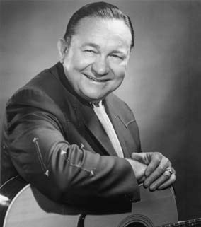 black and white photo of a man with a guitar