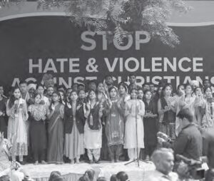 black and white photo of a group of men and women in front of a stop hate and violence against christians sign
