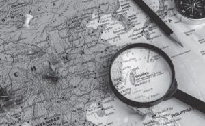 photo of a map with a magnifying glass on the country of taiwan