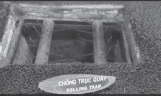 photo of a rolling trap, which has logs covered in long metal spikes