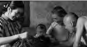 three adults coddle a baby