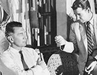 two men in suits speak to each other