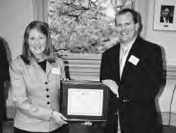 a man and woman hold a certificate