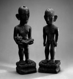 photo of two figures, including one holding a baby