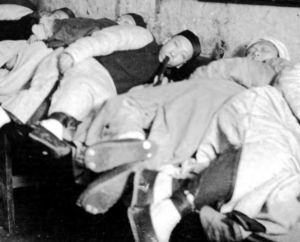 Image of people who lie down and smoke opium