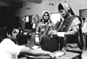 Images shows a woman is putting paper into a box
