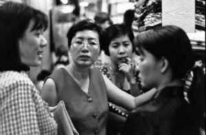 photo of a woman breaking up two arguing women