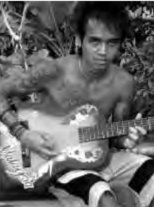 Photo of a man holding a guitar