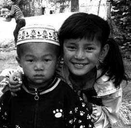 a boy and girl look into the camera, the girl is smiling